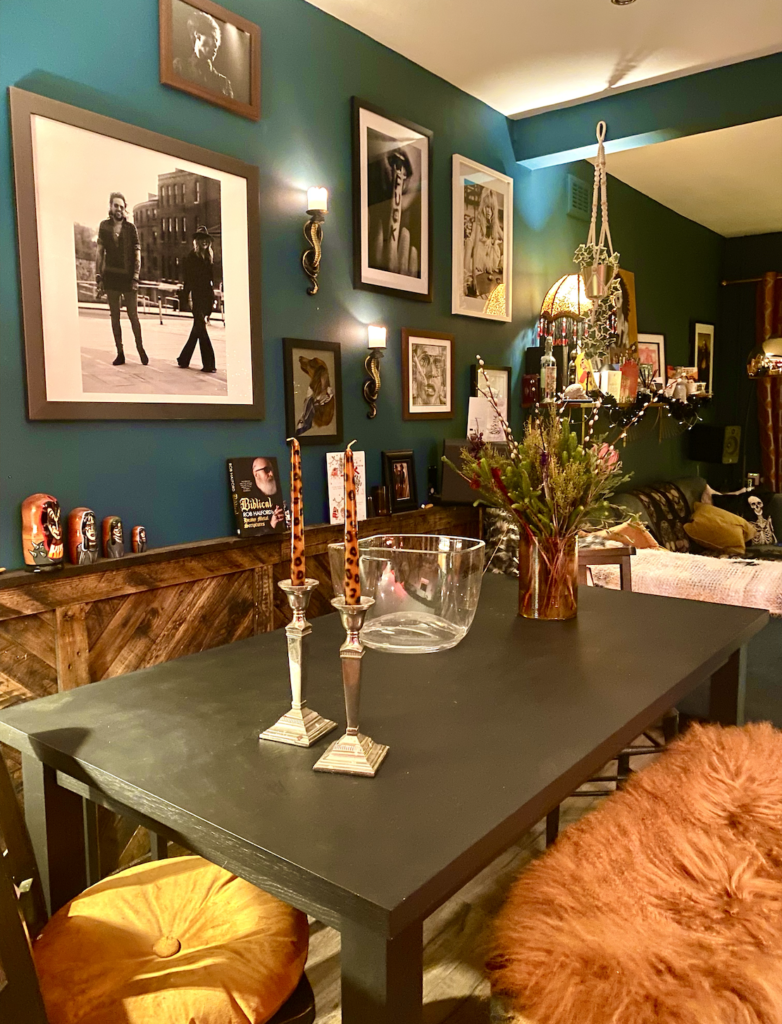 A dining table surrounded by maximalist decor and rich, warm colours. maximalist interiors