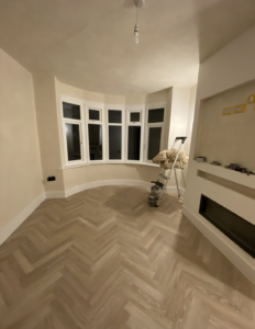 Living room with bay window colour drenched in limewash